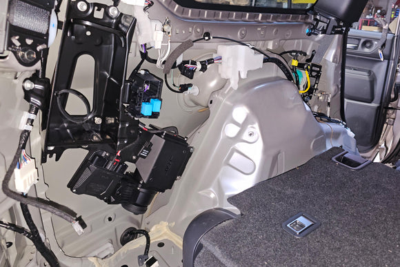 NSV Smart Air Compressor custom mounting bracket installed in Toyota Prado J250 cargo area — no drilling required